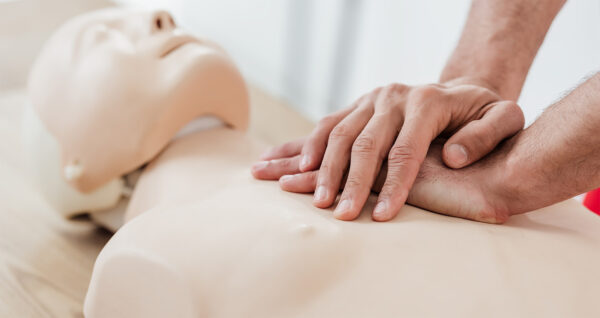 performing cpr on practice dummy